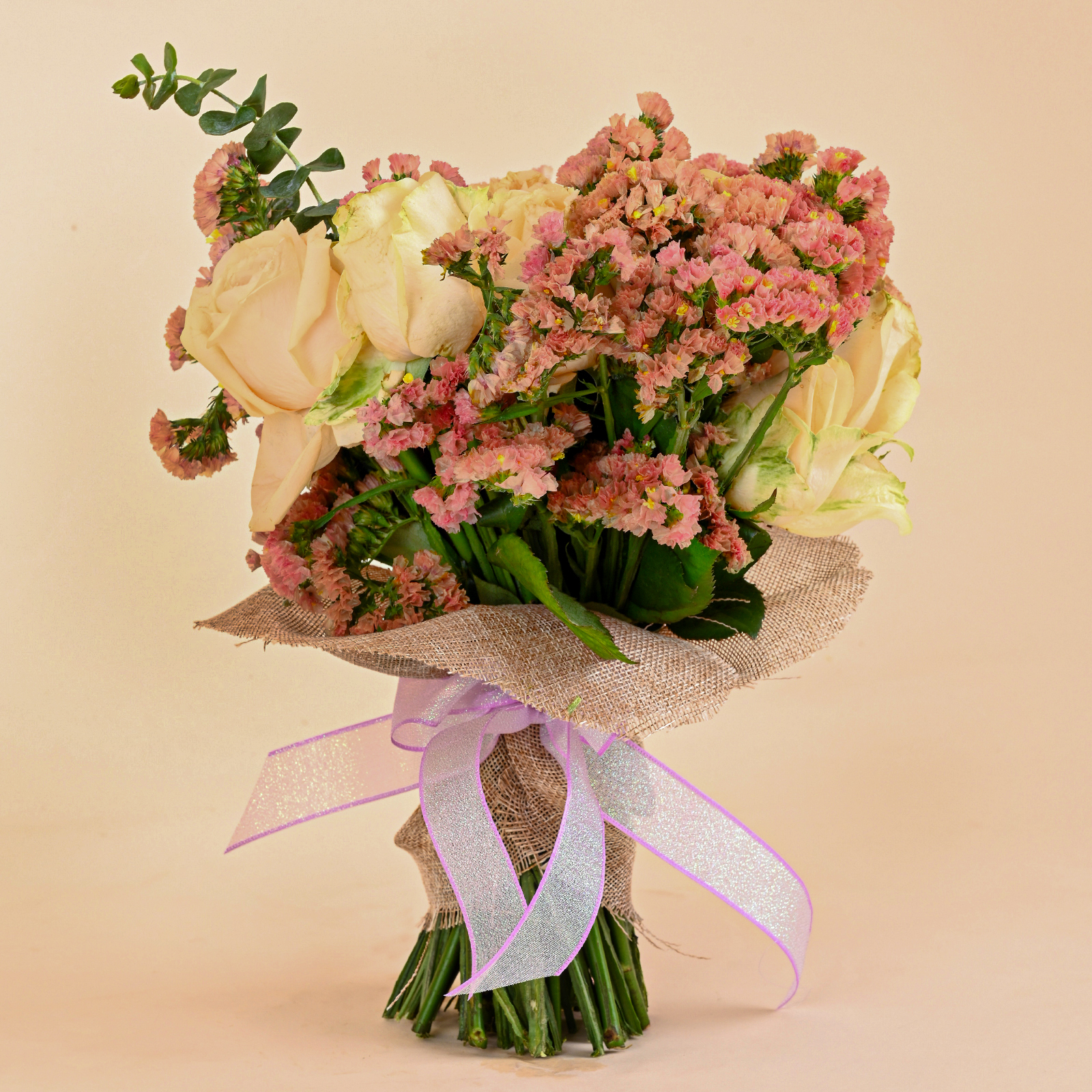 Peach Garden Glow bouquet with creamy peach roses, blush pink filler blooms, eucalyptus, jute wrap, and pastel ribbon by Rapid Petals by Yashken Fresh