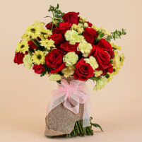 Sunlit Scarlet Bouquet with red roses, yellow carnations, yellow daisy blooms, jute wrap, and soft pink ribbon by Rapid Petals by Yashken Fresh